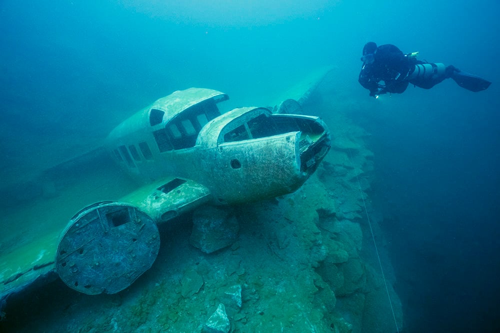 A small plane lies in a freshwater quarry in Quebec, one of the first stops on their expedition.